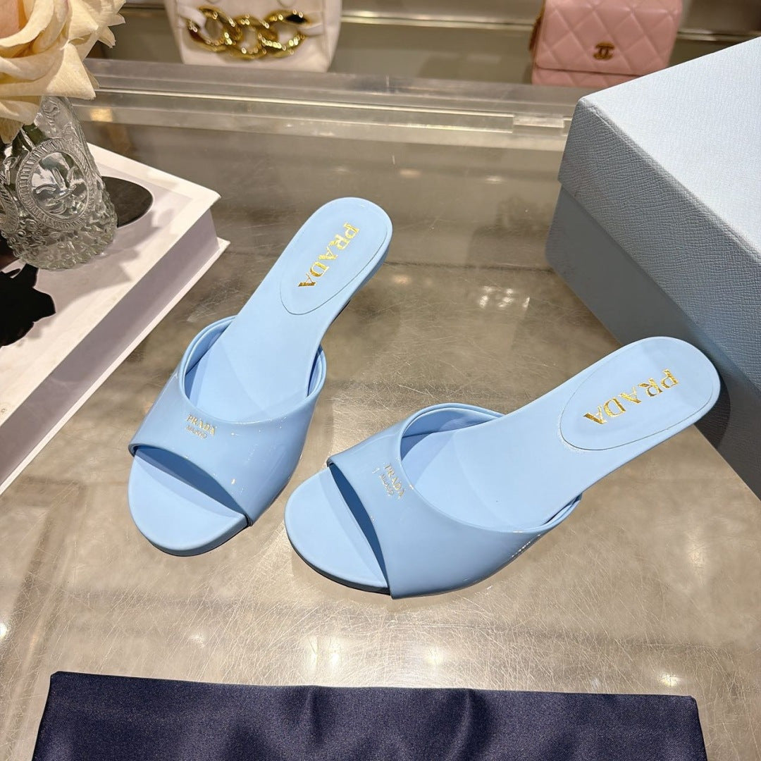 PRADA 26S LOGO EMBOSSED KITTEN HEEL MULES IN SKY BLUE PATENT CALFSKIN