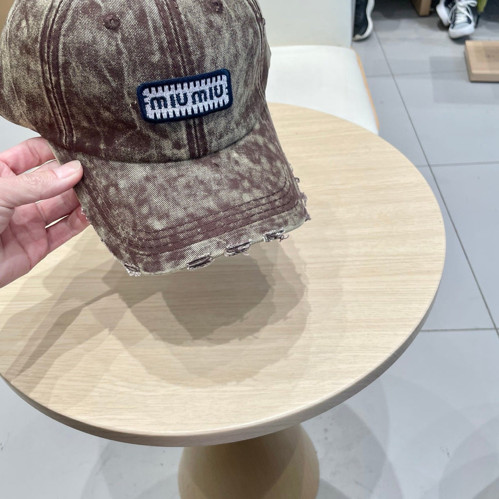 MIUMIU DISTRESSED FABRIC BASEBALL CAP IN BROWN WITH EMBROIDERED LOGO