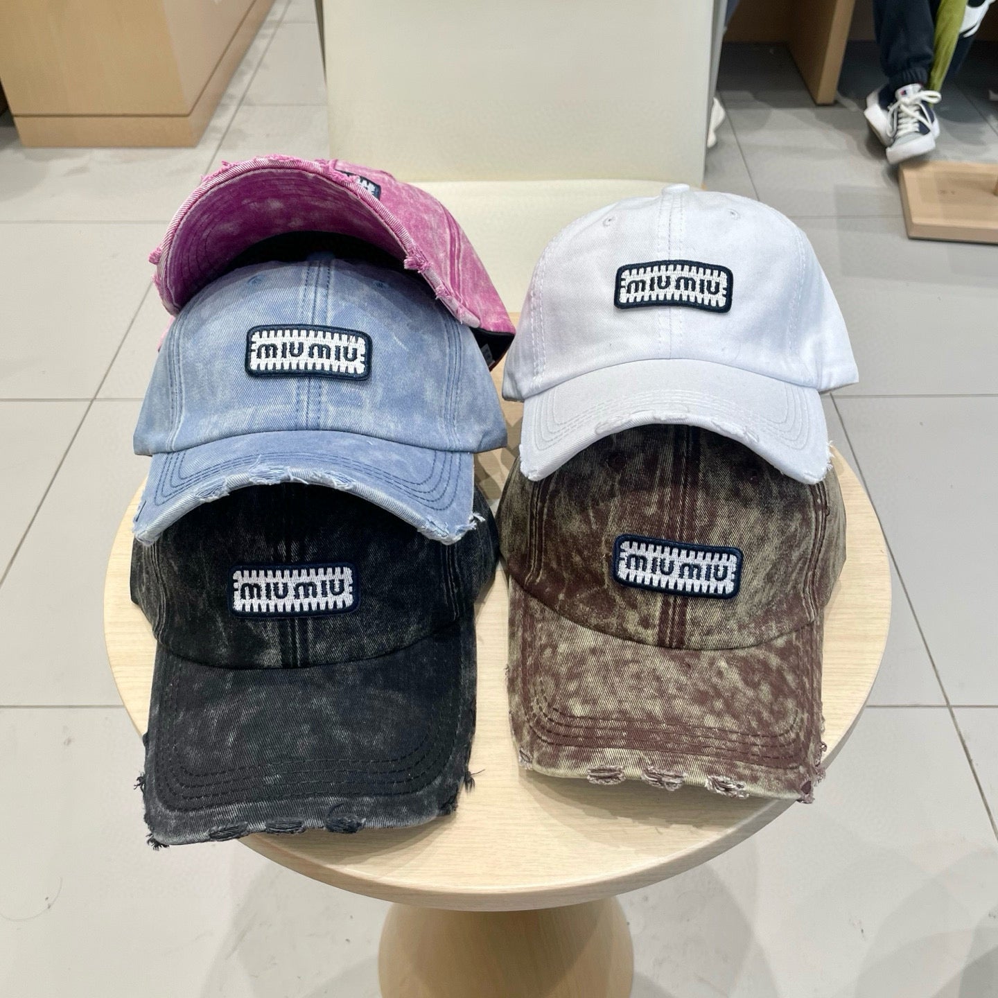 MIUMIU DISTRESSED FABRIC BASEBALL CAP IN BLACK WITH EMBROIDERED LOGO
