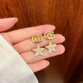GUCCI 26S DOUBLE G STAR CRYSTAL DROP EARRINGS IN GOLD TONE METAL 627015