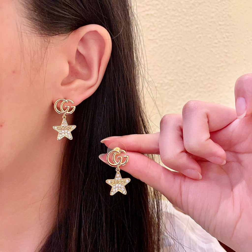 GUCCI 26S DOUBLE G STAR CRYSTAL DROP EARRINGS IN GOLD TONE METAL 627015