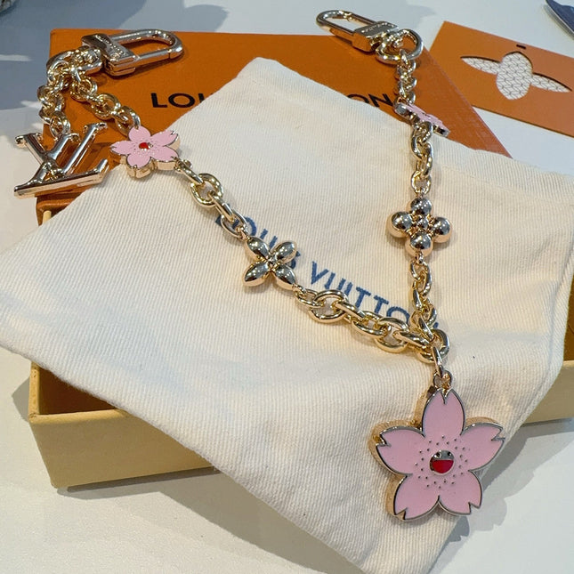 SAKURA BAG CHARM IN GOLD METAL HARDWARE