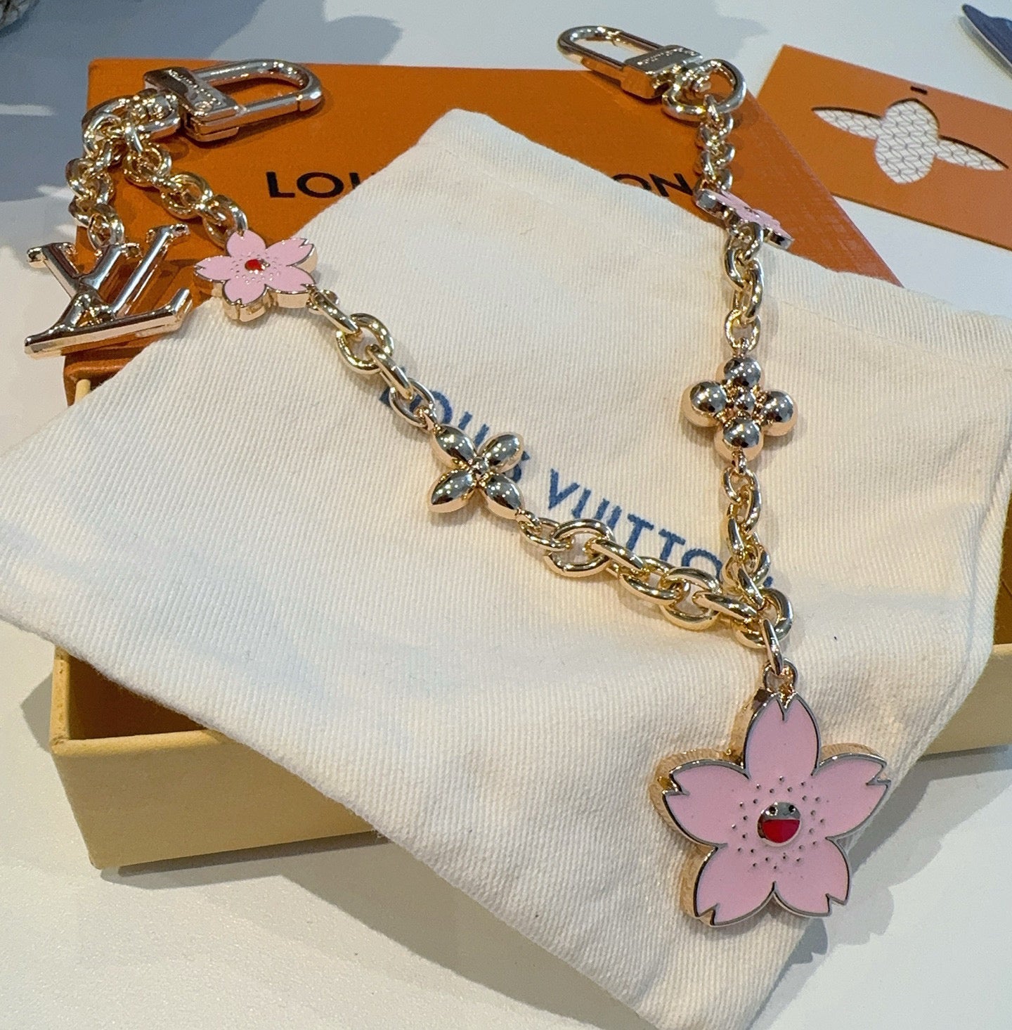 SAKURA BAG CHARM IN GOLD METAL HARDWARE