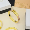 MIUMIU 26S LOGO HINGED BANGLE BRACELET WITH PINK ENAMEL IN GOLD TONE METAL