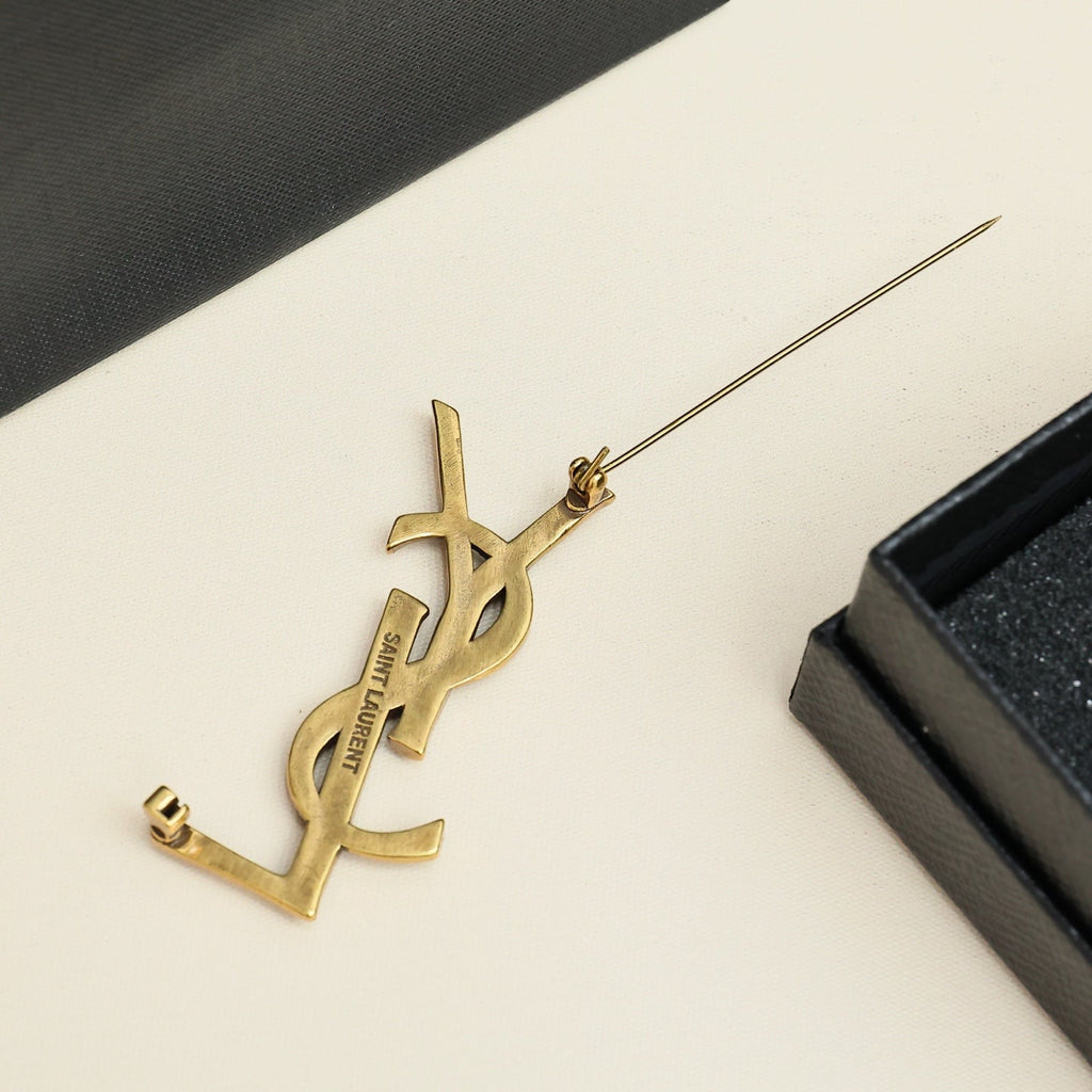 YSL 26S TEXTURED MONOGRAM BROOCH IN ANTIQUE GOLD TONE METAL