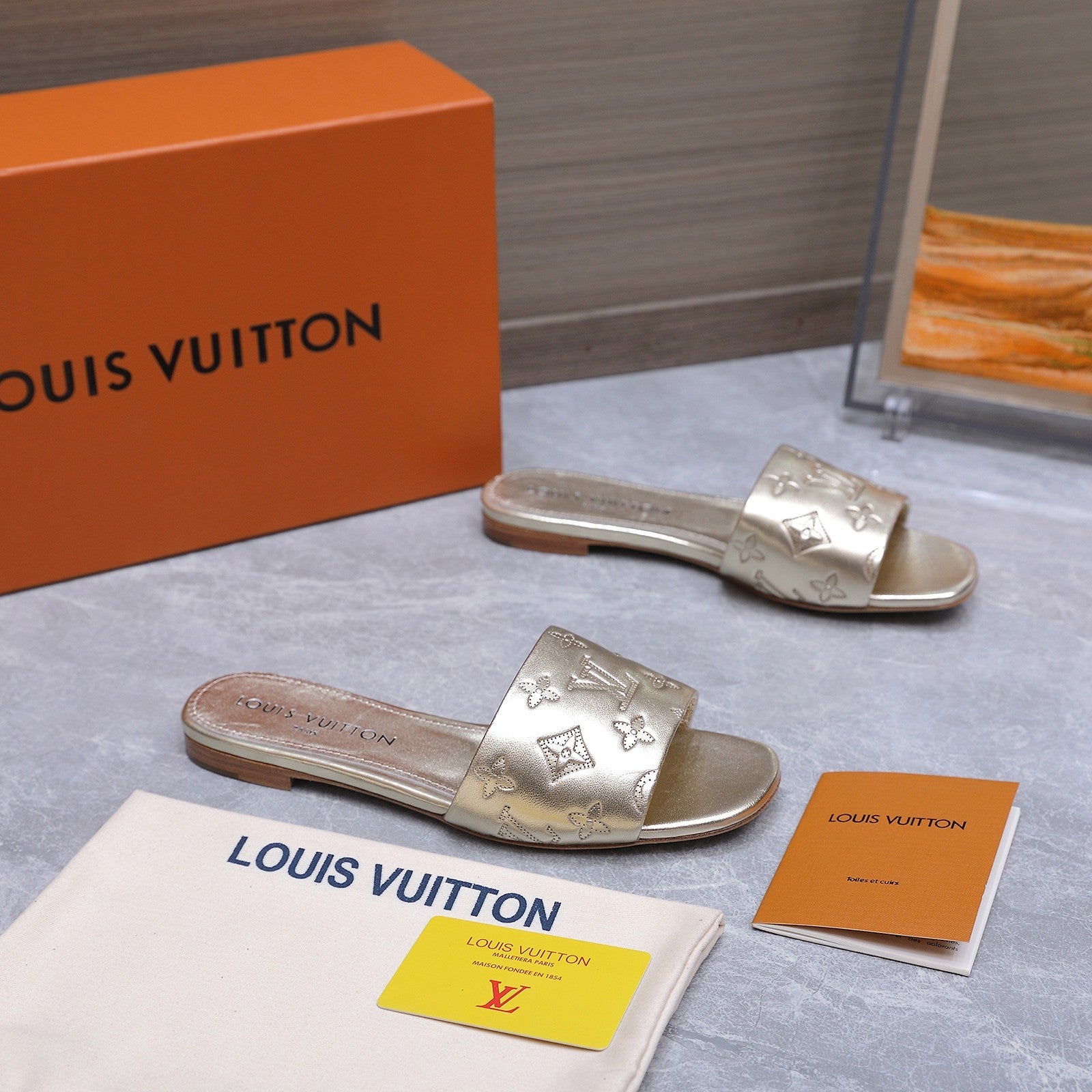 LV 26S FLAT SLIDE SANDALS IN GOLD CALFSKIN EMBOSSED MONOGRAM LOGO