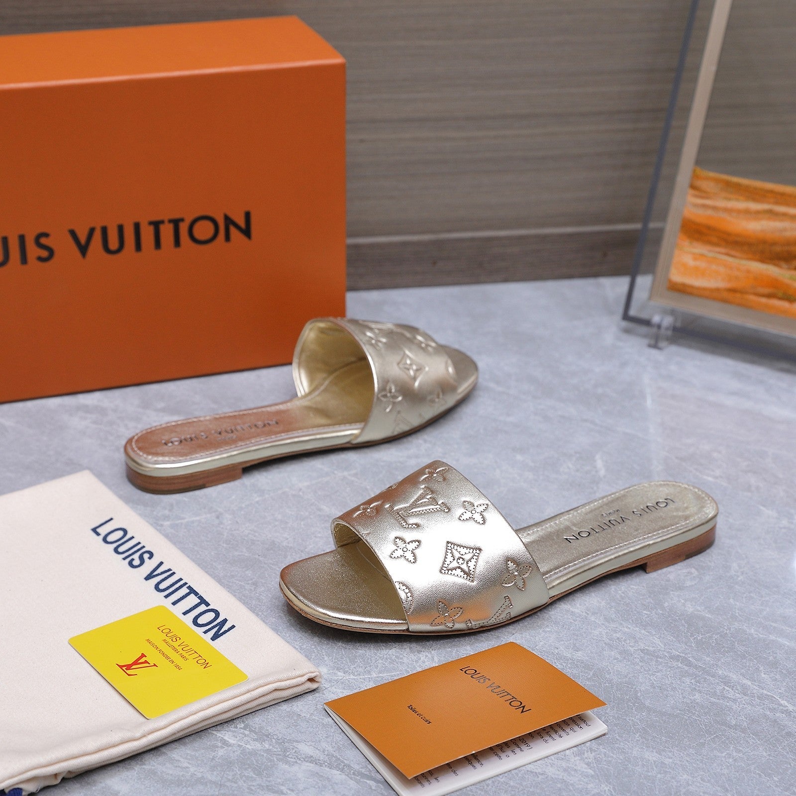 LV 26S FLAT SLIDE SANDALS IN GOLD CALFSKIN EMBOSSED MONOGRAM LOGO