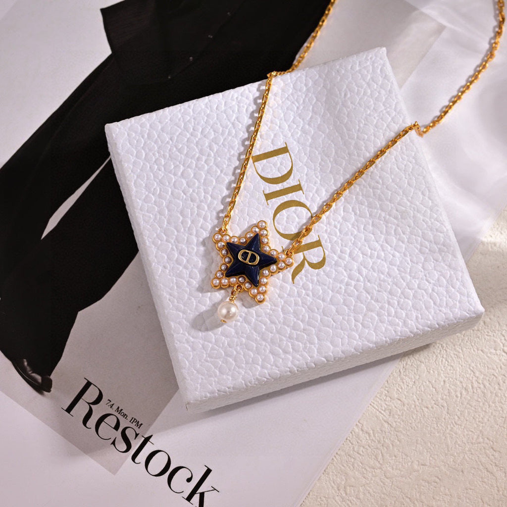CD 26S PEARL STAR LOGO PENDANT NECKLACE IN GOLD TONE METAL