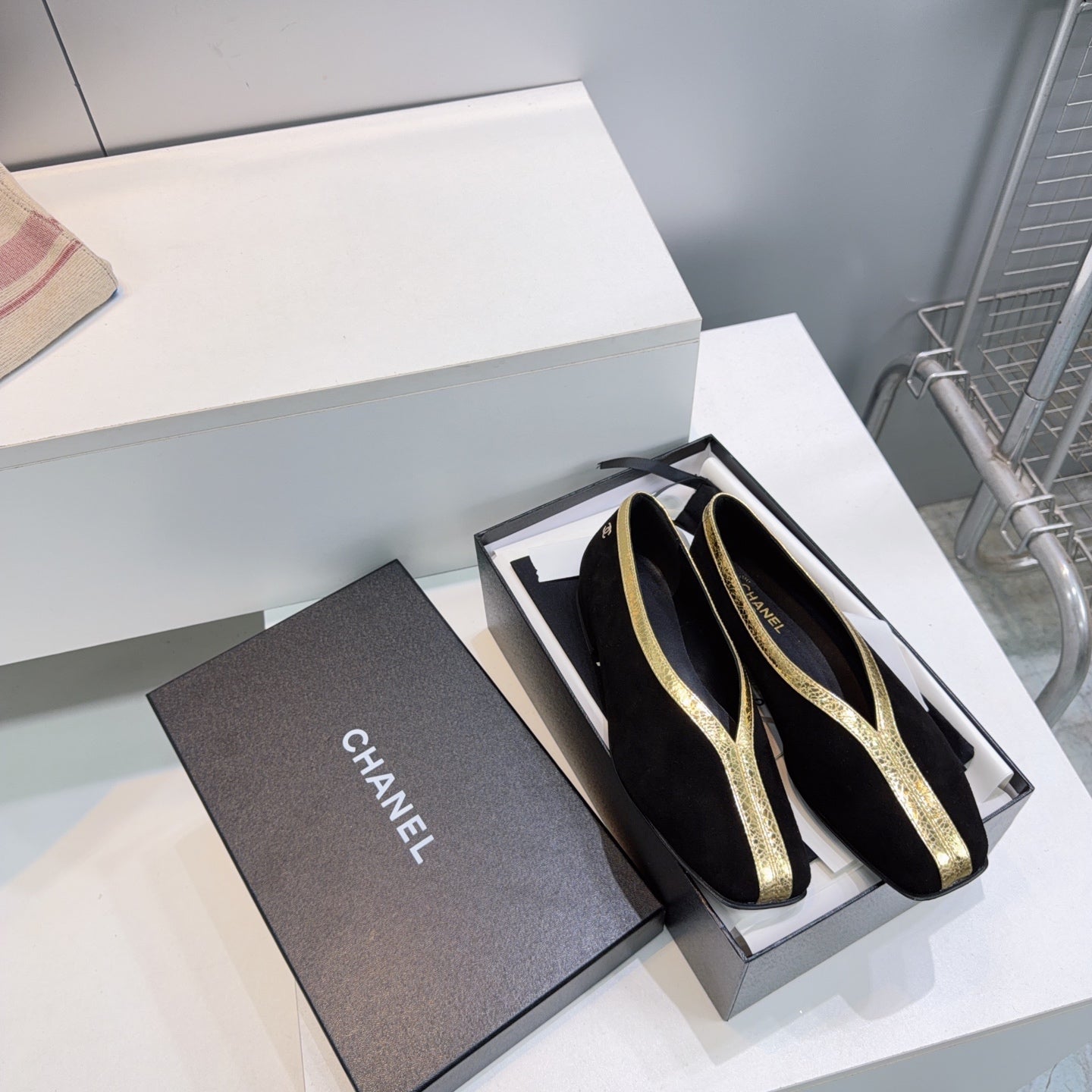 CHANEL 26S SQUARE-TOE FLATS IN BLACK SUEDE WITH GOLD PATENT TRIM