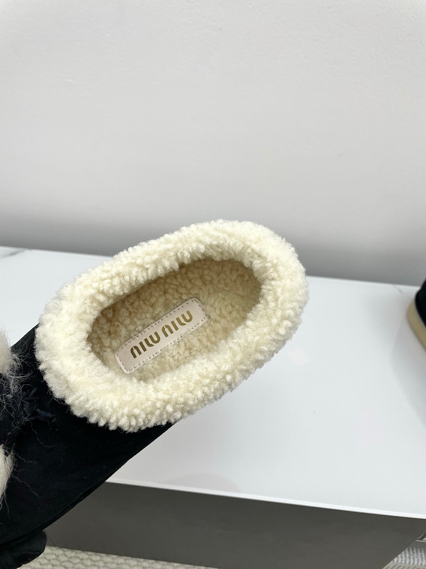 MIUMIU 26S ANKLE SHEARLING BOOTS IN BLACK SUEDE