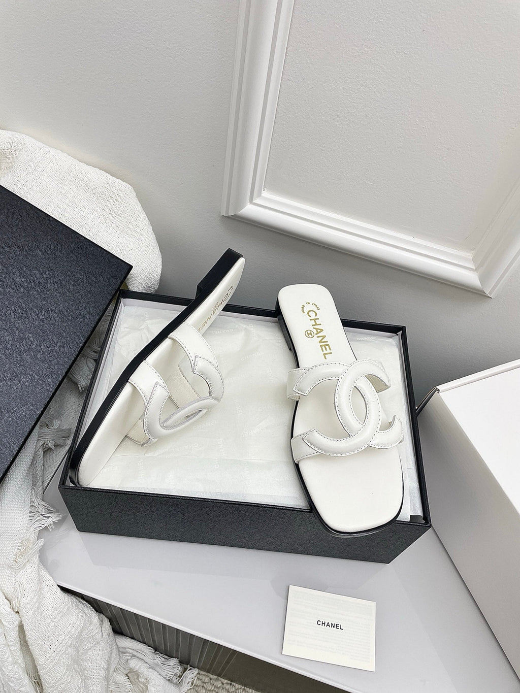 CHANEL CC LOGO MULES IN WHITE CALFSKIN