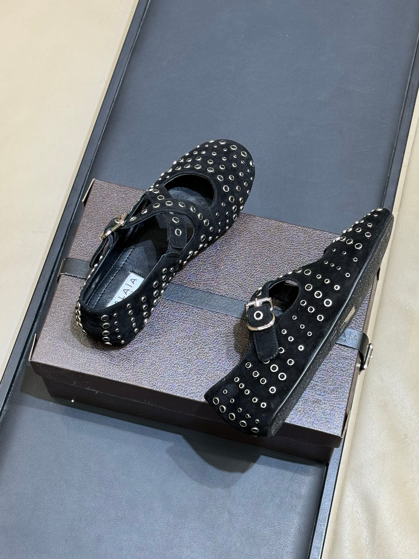 ALAIA 26S CROSS-STRAP FLATS IN BLACK SUEDE WITH SILVER HARDWARE