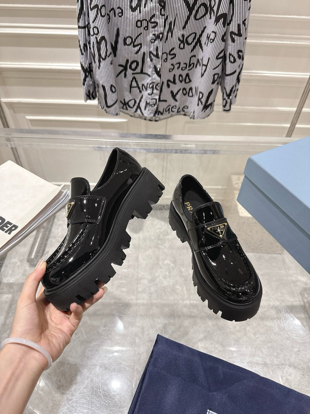 PRADA 26S PLATFORM LOAFERS 45MM IN BLACK PATENT CALFSKIN