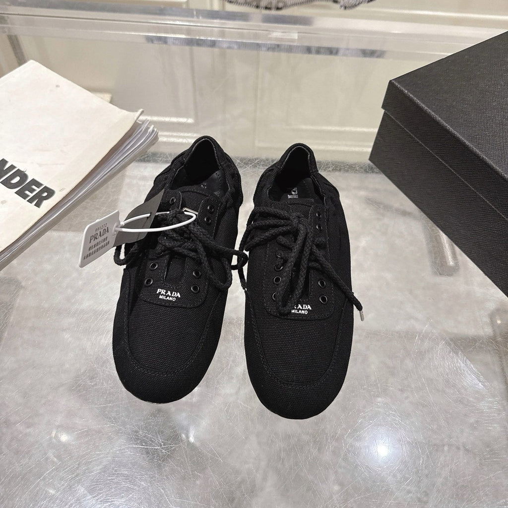 PRADA 26S COLLAPSE SNEAKERS IN BLACK CANVAS
