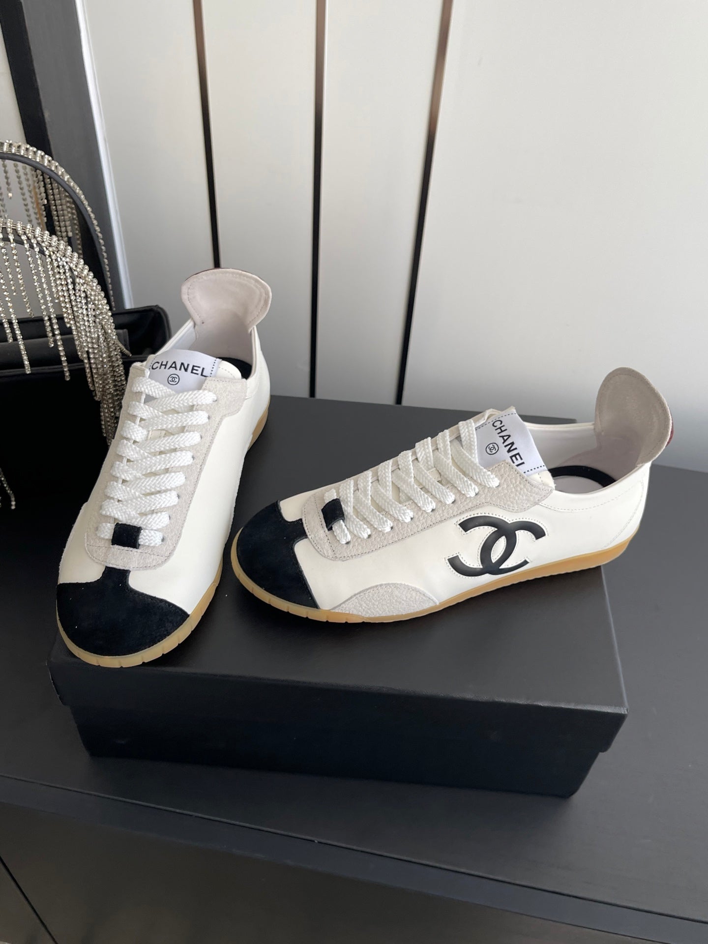 CHANEL LOW-TOP SNEAKERS IN BLACK AND WHITE CALFSKIN MIX SUEDE