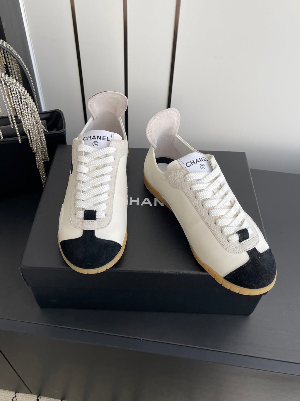 CHANEL LOW-TOP SNEAKERS IN BLACK AND WHITE CALFSKIN MIX SUEDE
