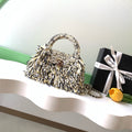 CHANEL 26S SMALL FRINGE KELLY 19 IN BLACK AND IVORY RAFFIA WOOD
